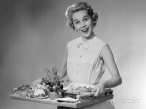 1950s-woman-smiling-holding-platter-of-hors-d-oeuvres-snacks